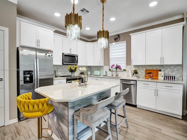 4414 Ficus St, Hollywood, FL 33021 - kitchen featuring a breakfast bar, a sink, stainless steel appliances, and a chandelier