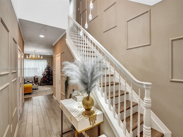 4414 Ficus St, Hollywood, FL 33021 - stairway featuring wood finished floors, a chandelier, and recessed lighting