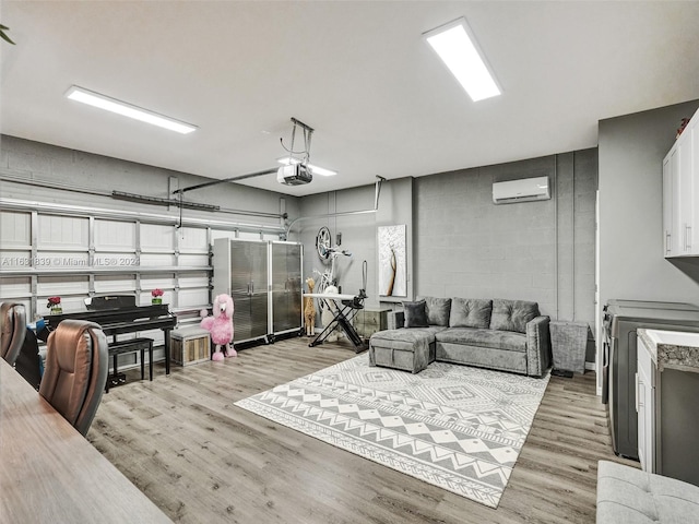 4414 Ficus St, Hollywood, FL 33021 - living room featuring concrete block wall, a wall mounted AC, a garage, and light wood-style flooring