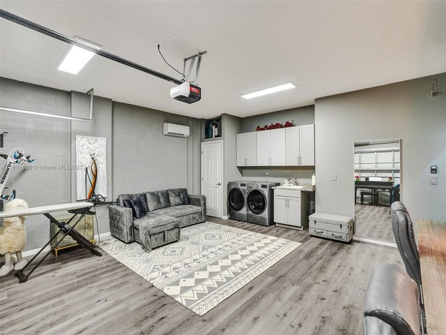 4414 Ficus St, Hollywood, FL 33021 - interior space featuring concrete block wall, a sink, separate washer and dryer, light wood-style floors, and cabinet space