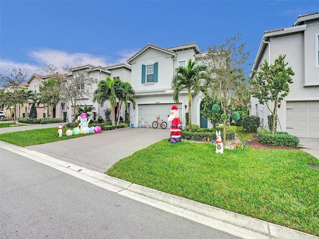 4414 Ficus St, Hollywood, FL 33021 - view of front of house with a front yard, stucco siding, an attached garage, a tiled roof, and decorative driveway