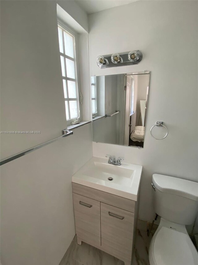 bathroom featuring vanity and toilet