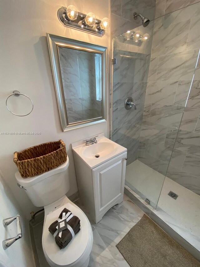 bathroom featuring tiled shower and vanity