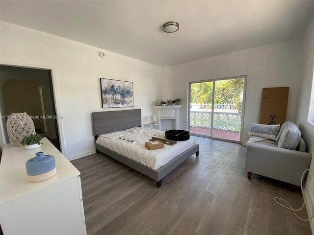 bedroom featuring dark wood-type flooring and access to exterior