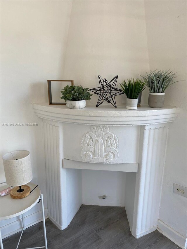 interior details featuring built in desk and hardwood / wood-style floors