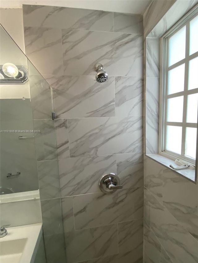 bathroom with a tile shower