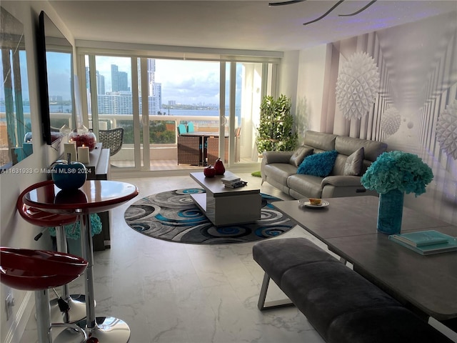 tiled living room featuring floor to ceiling windows