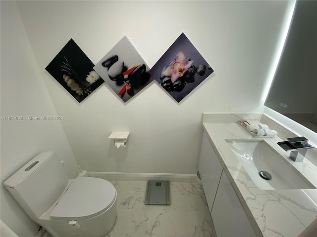 bathroom featuring vanity, tile patterned floors, and toilet