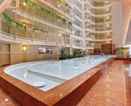 view of pool featuring a jacuzzi