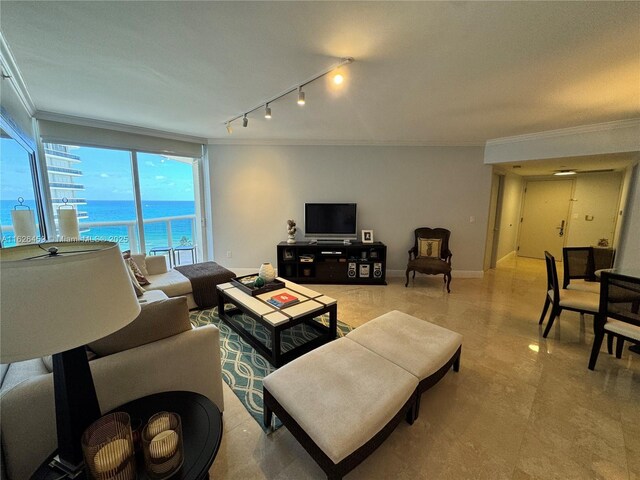 balcony featuring a water view and a beach view