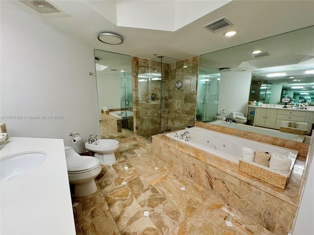 bathroom featuring vanity, toilet, and a bidet