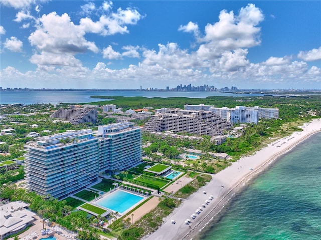 birds eye view of property with a water view and a view of the beach