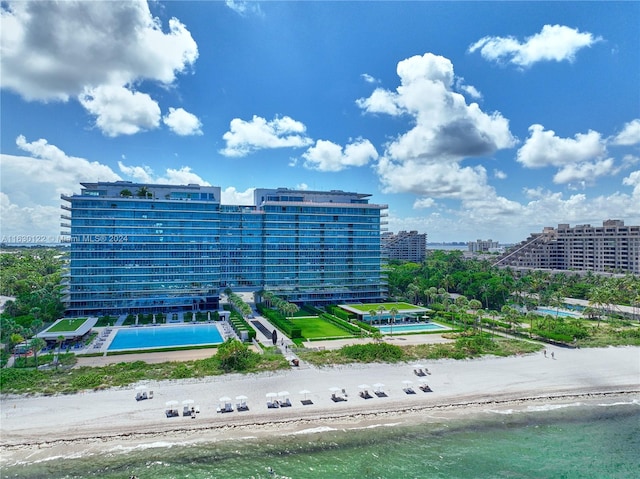 drone / aerial view with a water view and a view of the beach