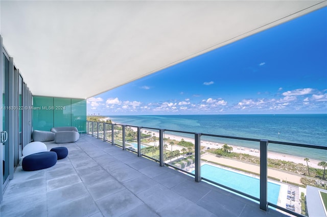 balcony featuring a water view and a view of the beach