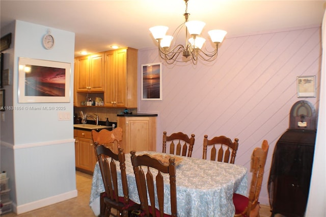 dining space with a chandelier and sink