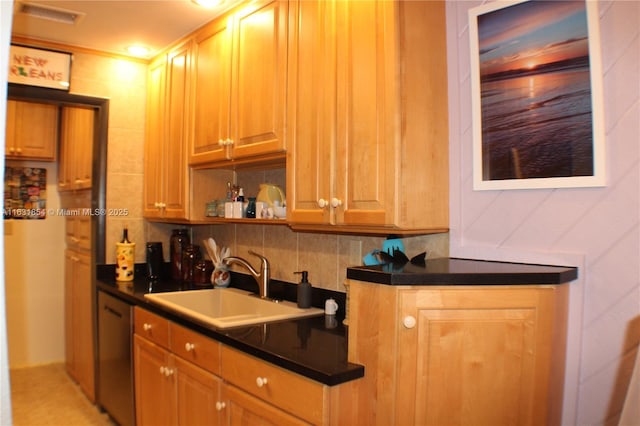 kitchen featuring tasteful backsplash, stainless steel dishwasher, and sink