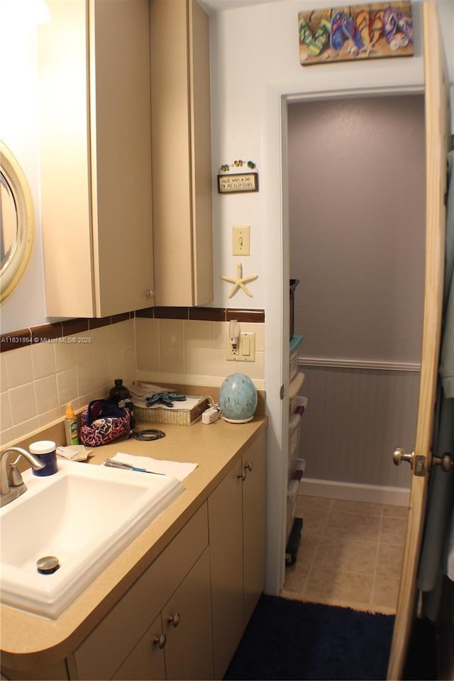 bathroom featuring decorative backsplash, tile patterned flooring, and vanity