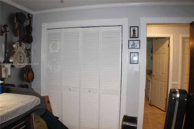 bedroom featuring crown molding and a closet