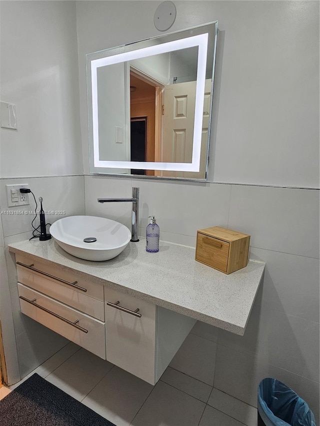 bathroom with tile patterned floors, vanity, backsplash, and tile walls