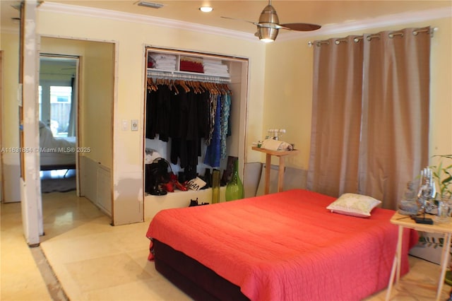 bedroom featuring a closet, ceiling fan, and crown molding