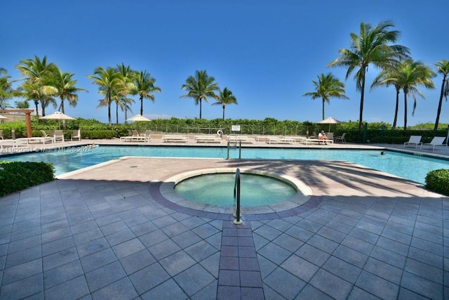 view of swimming pool with a community hot tub and a patio