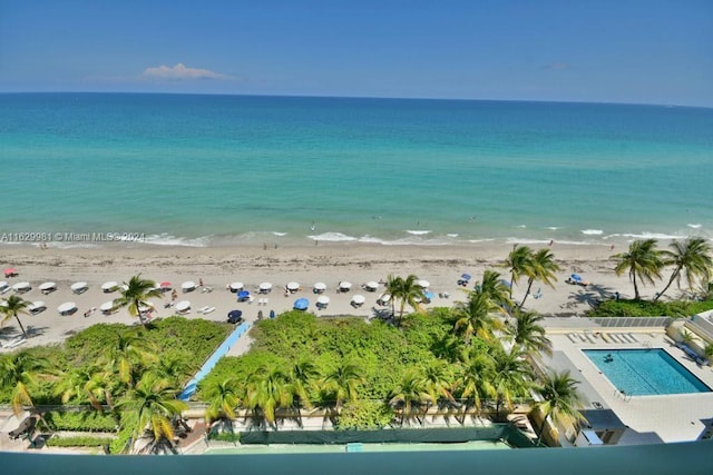 drone / aerial view featuring a water view and a view of the beach