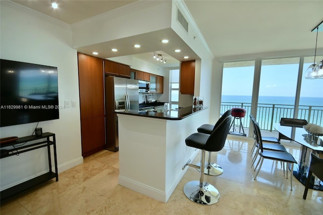 kitchen with a kitchen bar, a water view, crown molding, appliances with stainless steel finishes, and kitchen peninsula