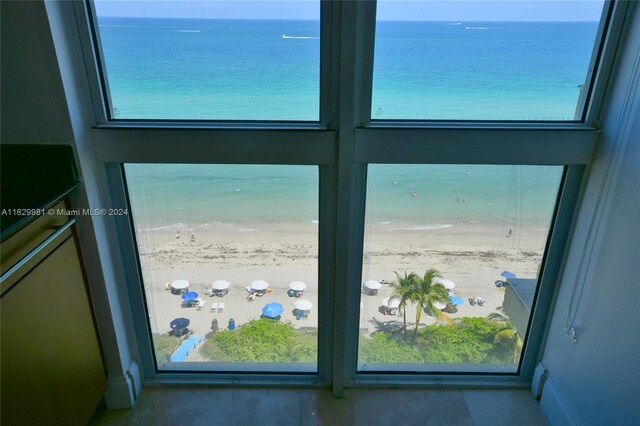 interior space with a water view and a view of the beach