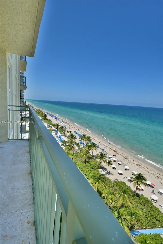 balcony featuring a water view and a view of the beach