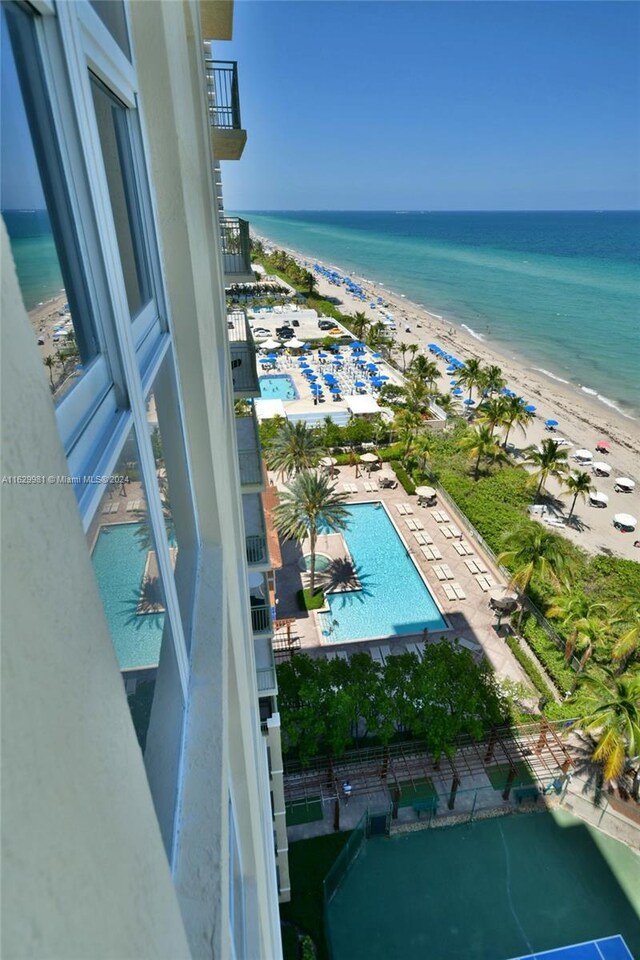 exterior space with a water view and a view of the beach