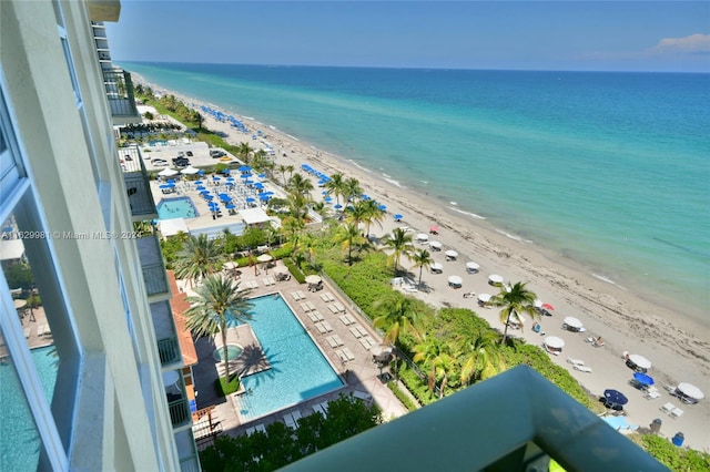 birds eye view of property featuring a water view and a beach view