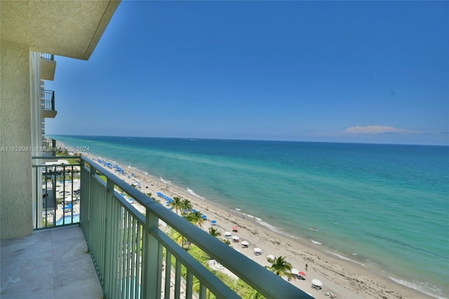 balcony with a water view and a beach view