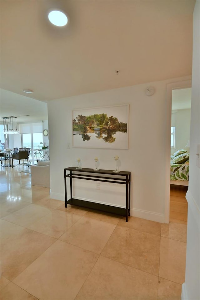 corridor featuring light tile patterned flooring