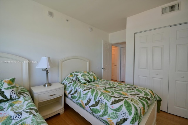 bedroom featuring wood-type flooring and a closet