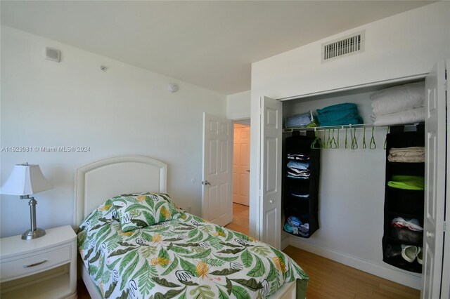 bedroom with a closet and hardwood / wood-style floors