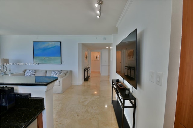 hall featuring track lighting, light tile patterned floors, and ornamental molding