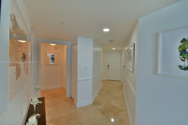 hall with light tile patterned floors