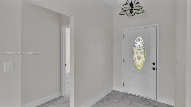 entrance foyer with light tile patterned flooring and a notable chandelier