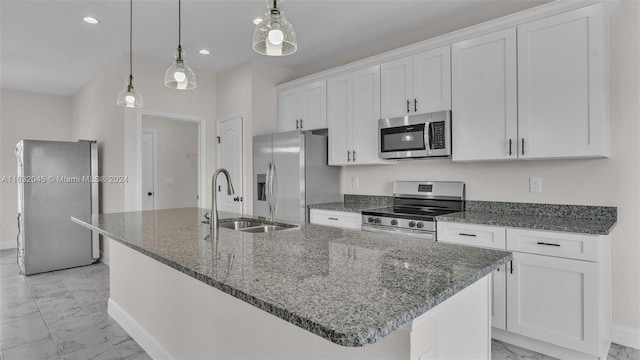 kitchen featuring stainless steel appliances, sink, an island with sink, light tile patterned flooring, and white cabinetry