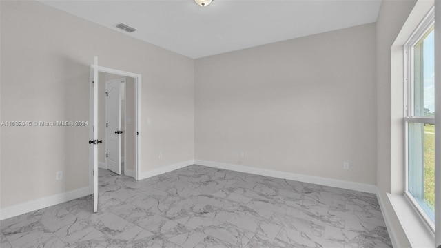 unfurnished room featuring light tile patterned floors