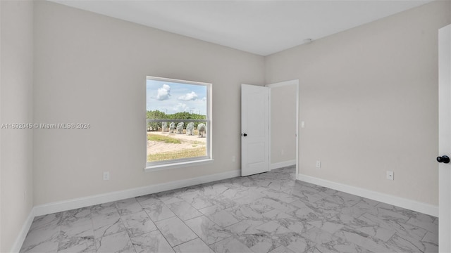 unfurnished room featuring light tile patterned floors