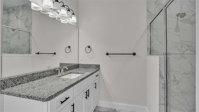 bathroom with a shower with door, vanity, and tile patterned floors