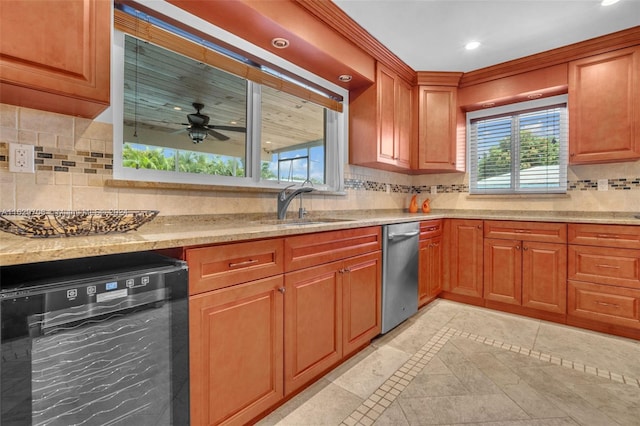 kitchen featuring dishwasher, stainless steel dishwasher, light stone counters, and light tile patterned floors