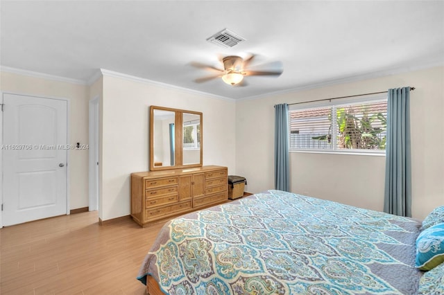 bedroom with hardwood / wood-style floors, crown molding, and ceiling fan