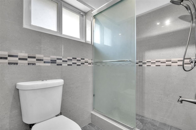 bathroom with toilet and an enclosed shower