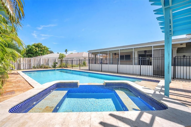 view of pool with an in ground hot tub and a sunroom