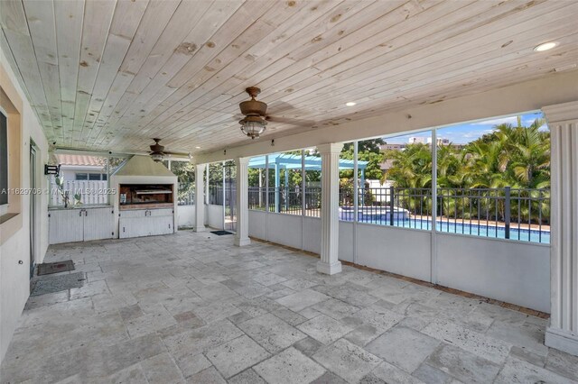 rear view of property featuring a patio and a sunroom