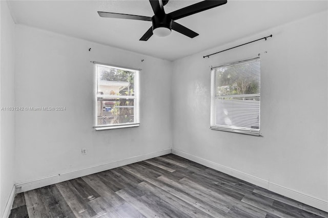 unfurnished room with baseboards, wood finished floors, and a ceiling fan