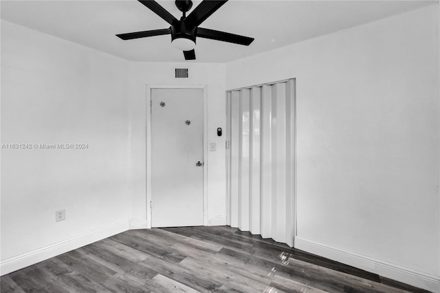 empty room featuring visible vents, baseboards, wood finished floors, and a ceiling fan