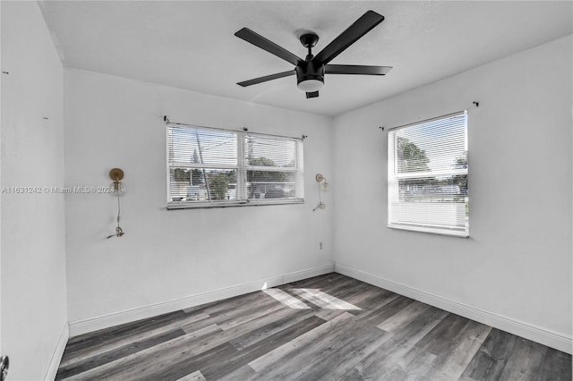 empty room with ceiling fan, baseboards, and wood finished floors